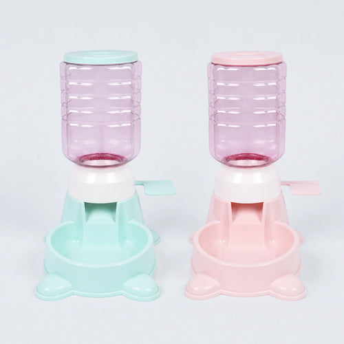 Mint green and pale pink 1.8 L paw-press interactive pet feeders on a cool gray-blue background