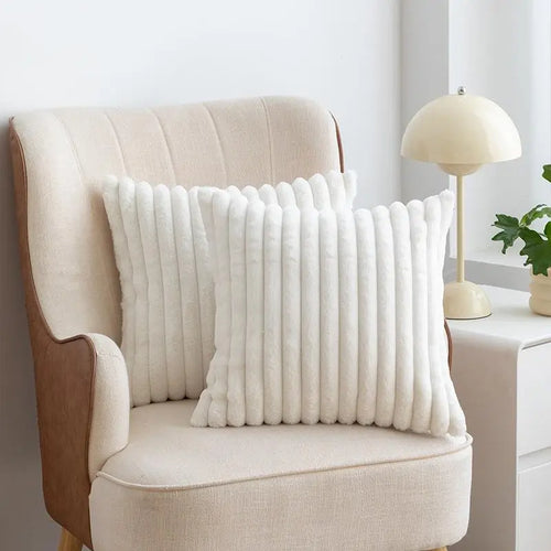 Plush faux-fur pillow covers styled on a neutral sofa
