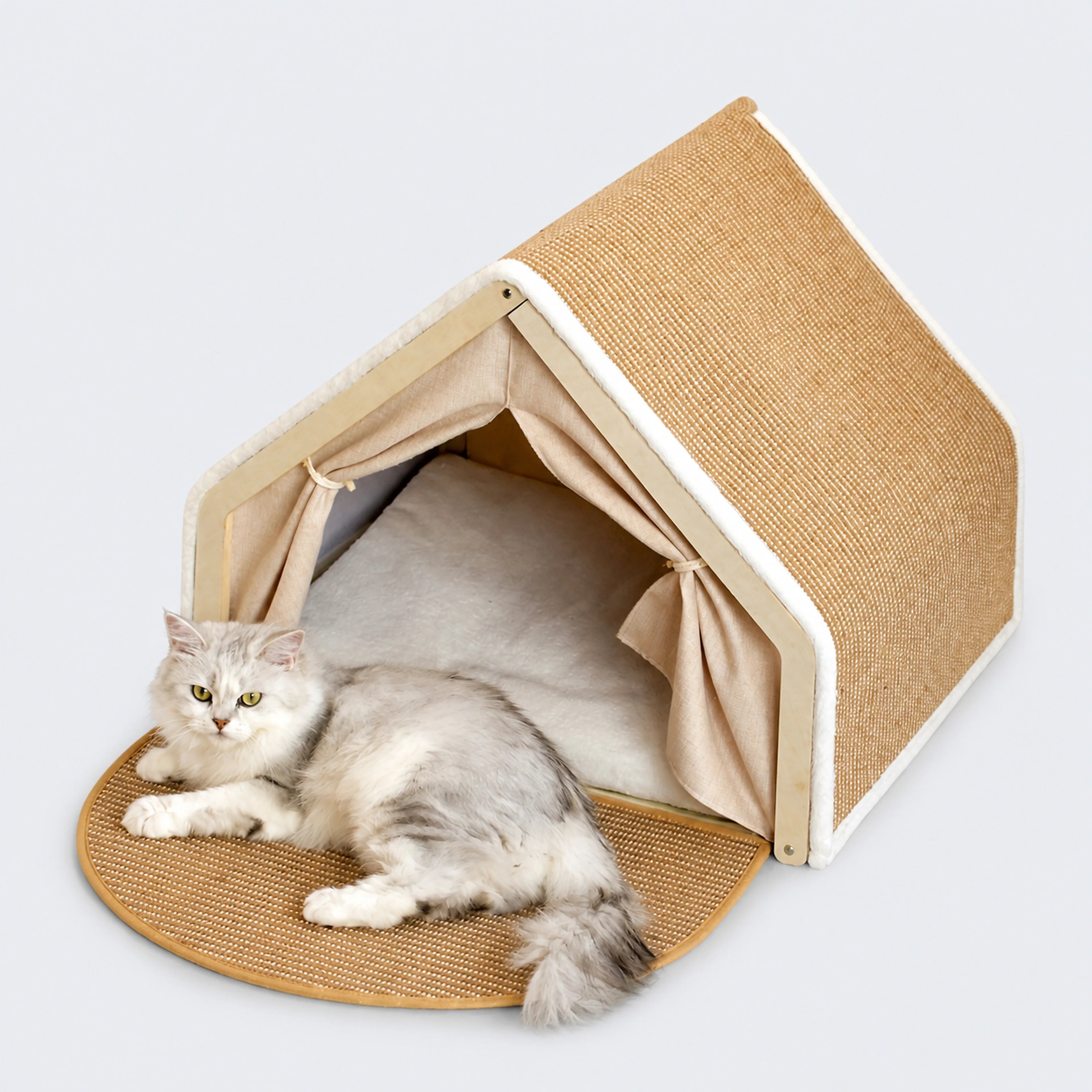 A-frame wooden cat scratcher house with a cat on a cool gray-blue background