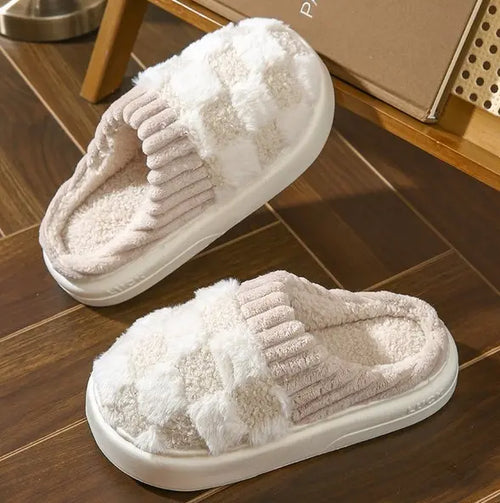 White plaid-cuff indoor slippers in a warm home setting