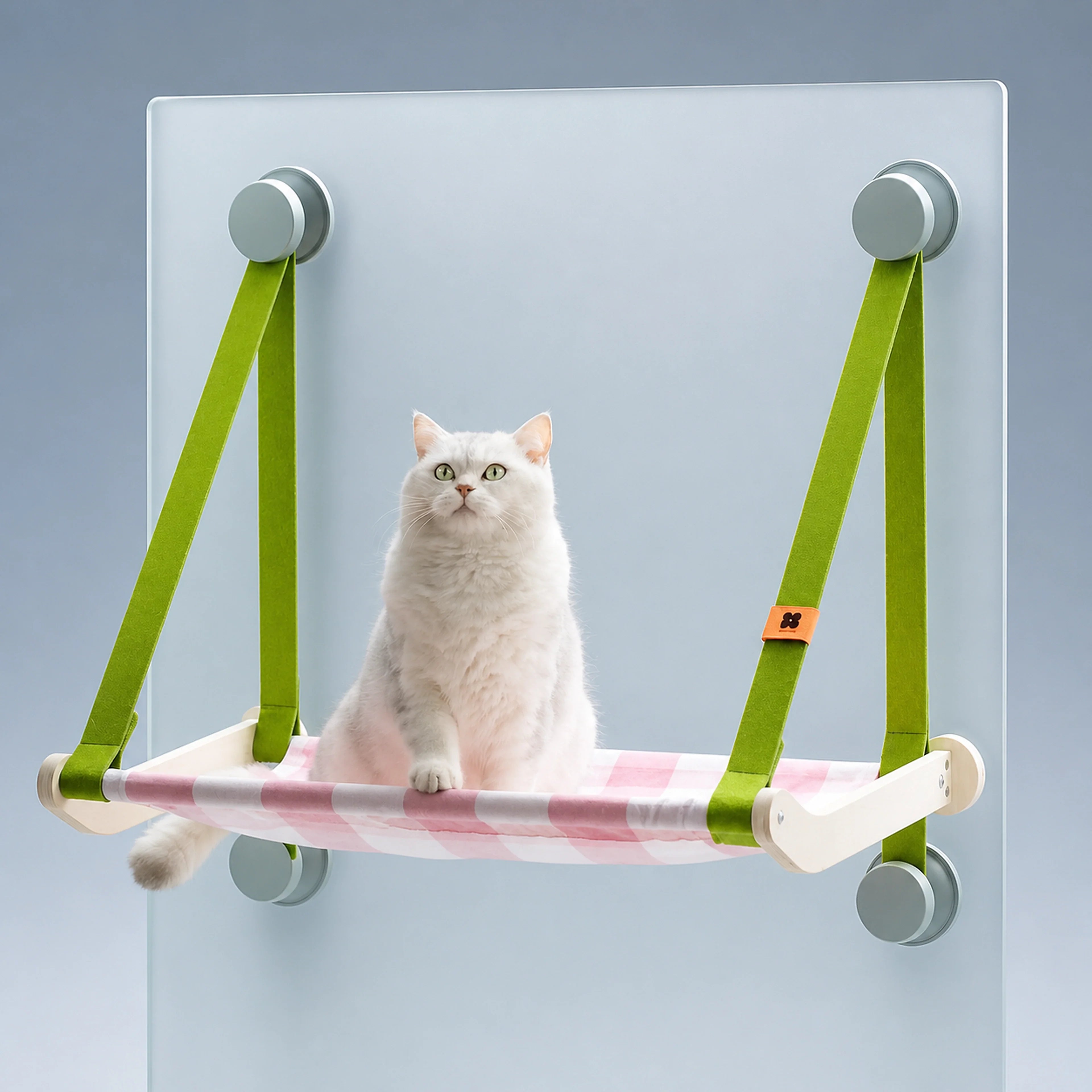 Suspended cat window hammock with green straps and a white cat on a cool gray-blue background