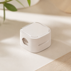 Off-white cable organizer clip on a warm neutral surface