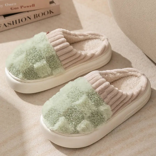 Sage green plaid-cuff indoor slippers on a warm neutral surface