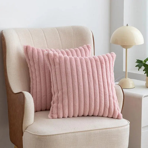 Set of two plush faux-fur pillow covers in a neutral home setting